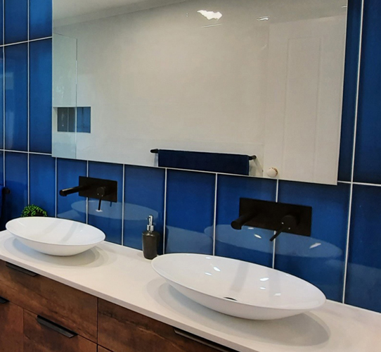 Blue tiles and twin vanity basins for this beautiful bathroom renovation by Star Bathrooms and Renovations, Keppera.