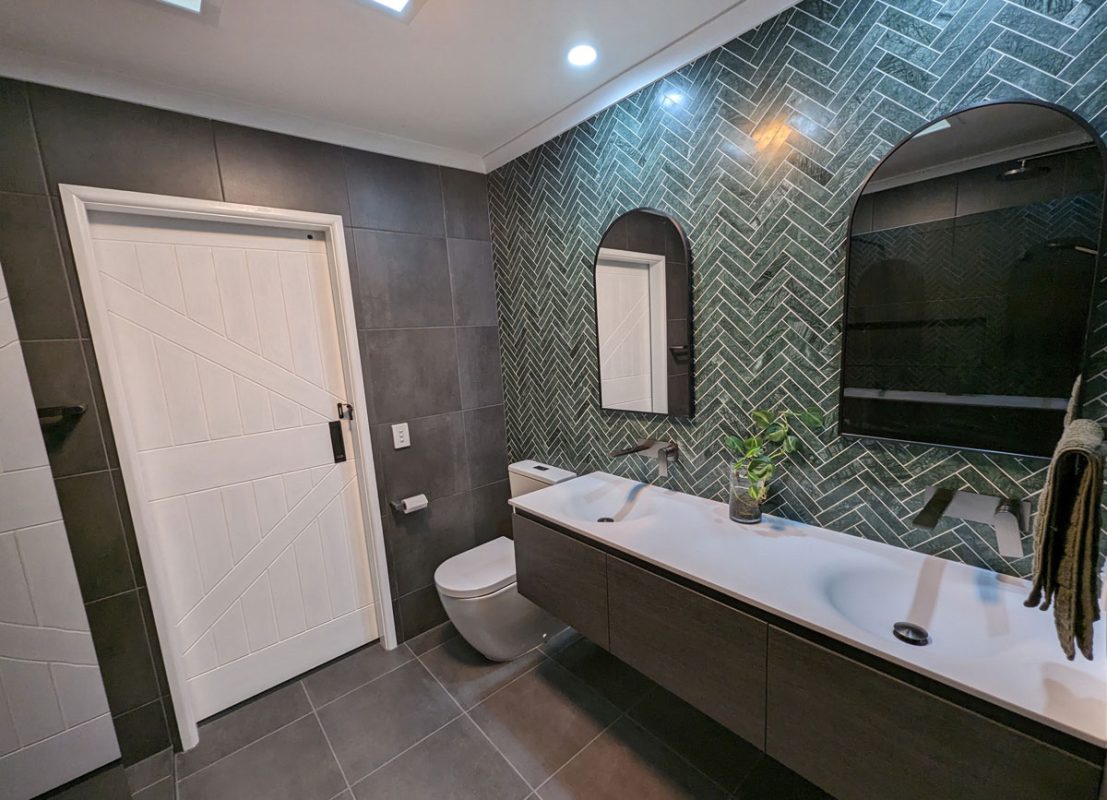 Bathroom makeover in cool green herringbone tiles by Star Bathrooms and Renovations experts in Bathroom renovations.